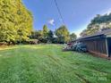 Expansive backyard with lush greenery, storage shed and ample space for outdoor activities at 1229 Rocky Face Church Rd, Taylorsville, NC 28681