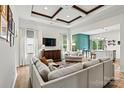 A living room with a coffered ceiling, open to the kitchen area, and a wall of windows at 139 Batten Ridge Dr, Statesville, NC 28677