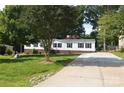 Charming home with a long concrete driveway and lush green lawn at 14335 Saint Johns Dr # 83, Stanfield, NC 28163
