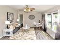 Cozy living room with plush gray sofa, decorative lighting, and windows for natural light at 14335 Saint Johns Dr # 83, Stanfield, NC 28163