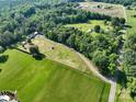 Expansive aerial view showcases property and lush greenery with mature trees and winding drive at 16132 Mclester Rd, Oakboro, NC 28129