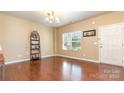Sunlit living room with gleaming hardwood floors and neutral walls at 1905 Yellow Daisy Dr, Matthews, NC 28104