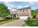 Attractive two-story home with a two-car garage, landscaped front yard, and inviting curb appeal at 1905 Yellow Daisy Dr, Matthews, NC 28104
