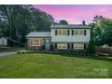 Charming two-story home with well-manicured lawn, brick accents, and lush landscaping creating curb appeal at 205 Wingate Dr, Stanley, NC 28164