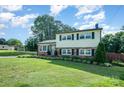 Charming two-story home featuring a lush lawn and classic architectural style at 205 Wingate Dr, Stanley, NC 28164