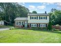 Charming two-story home with well-manicured lawn, brick accents, and lush landscaping creating curb appeal at 205 Wingate Dr, Stanley, NC 28164