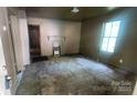 Living room with large window, hardwood floors, and a decorative fireplace at 210 Mahan Sw St, Concord, NC 28025