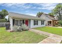 Charming single-story home with a manicured lawn, inviting entrance, and mature landscaping at 2117 Yadkin Ave, Charlotte, NC 28205