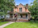 Beautiful two-story house with a charming front porch and well-maintained lawn at 217 S Ellis St, Salisbury, NC 28144