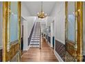 Elegant foyer featuring hardwood floors, chandelier, and staircase at 217 S Ellis St, Salisbury, NC 28144