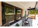 Inviting covered front porch with rocking chairs, natural wood columns, and charming details at 2220 Mooresville Rd, Salisbury, NC 28147