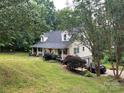 Well-maintained home on a lush green lawn with mature trees providing privacy and a garage at 223 Tennessee Trl, Lincolnton, NC 28092