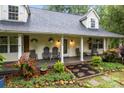 Inviting front porch with decorative plants and cozy seating, perfect for relaxing at 223 Tennessee Trl, Lincolnton, NC 28092