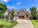 Beautiful brick home with a three-car garage and a meticulously maintained front yard with landscaping at 2325 Perry Rd, Denver, NC 28037