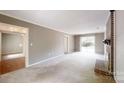Expansive living room with a brick fireplace and access to another room and outdoor space at 2507 Birnen Dr, Charlotte, NC 28210