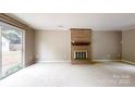 Spacious living room with a brick fireplace and a sliding door leading to the outdoors at 2507 Birnen Dr, Charlotte, NC 28210