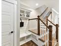 Bright entryway featuring custom mudroom bench, shelving, and staircase with stylish wood and white accents at 2517 Marlowe Ave, Charlotte, NC 28208