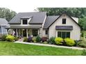 Beautiful landscaped lawn with covered front porch and modern farmhouse design elements at 2656 Lee Lawing Rd, Lincolnton, NC 28092