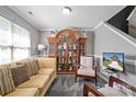 Cozy living room with neutral tones, large cabinet, and comfortable seating area, ideal for relaxation at 2809 Waycross Dr, Monroe, NC 28110