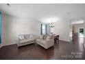 Bright and airy living room with hardwood floors, neutral paint, and furniture with backyard view at 3015 Liddington Rd, Matthews, NC 28105