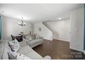 Spacious living room with a dining area, neutral paint, hardwood floors, and ample natural light at 3015 Liddington Rd, Matthews, NC 28105