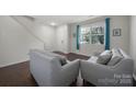 Inviting living room featuring hardwood floors, neutral paint, comfortable seating, and natural light at 3015 Liddington Rd, Matthews, NC 28105
