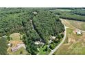 Scenic aerial view capturing multiple homesites in a lush, wooded area near roads and open fields at 3151 Lynn Mountain Rd, Vale, NC 28168