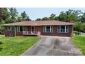 Charming brick home with a well-maintained lawn, featuring a classic design and welcoming front porch at 3151 Lynn Mountain Rd, Vale, NC 28168