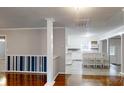 Bright living room featuring hardwood floors, neutral paint, and an open layout leading into the kitchen at 3151 Lynn Mountain Rd, Vale, NC 28168