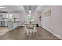Dining room with hardwood floors, a modern light fixture, and abundant natural light from the doors at 350 Moose Dr, Stony Point, NC 28678