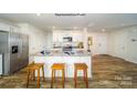 Bright kitchen features granite countertops, stainless steel appliances, and an island with barstool seating at 3740 13Th Ne St, Hickory, NC 28601
