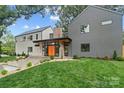 Contemporary home with a well-manicured lawn and modern architectural design at 3822 Topsfield Rd, Charlotte, NC 28211
