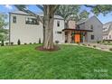 Landscaped front yard with an established tree and modern home facade at 3822 Topsfield Rd, Charlotte, NC 28211