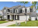 Stylish gray two-story home with white trim, a two-car garage, and manicured landscaping at 4029 Spring Garden St, Fort Mill, SC 29715
