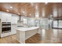 Open-concept kitchen featuring a large island, white cabinets, and stainless steel appliances at 4029 Spring Garden St, Fort Mill, SC 29715