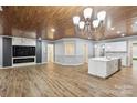 Spacious living room with hardwood floors, custom ceiling, fireplace, and open to kitchen at 4029 Spring Garden St, Fort Mill, SC 29715