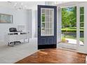 Bright foyer with hardwood floors, a view into the adjacent office, and an open doorway to the outdoors at 5005 Hedgebrook Ln, Waxhaw, NC 28173