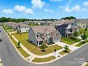 Beautiful aerial view of a landscaped neighborhood showcasing well-maintained homes and green spaces at 5114 Whispy Vines Ln, Huntersville, NC 28078