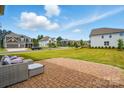 Cozy backyard patio with outdoor seating, surrounded by lush green lawn and neighborhood views at 5114 Whispy Vines Ln, Huntersville, NC 28078