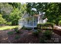 Quaint home with a welcoming front porch and well-manicured landscaping, creating a cozy curb appeal at 517 Powell St, Rock Hill, SC 29732