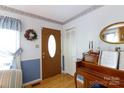 Inviting foyer with hardwood floors, showcasing a decorative wreath and a charming piano at 517 Powell St, Rock Hill, SC 29732