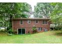 Brick home back exterior features sliding door and large windows, enhancing natural light and outdoor connection at 661 Blackwelder Rd, Statesville, NC 28625