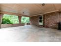 Expansive covered patio featuring brick columns, perfect for outdoor entertaining and relaxation with ample space at 661 Blackwelder Rd, Statesville, NC 28625