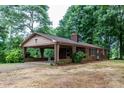 Single-story brick home with covered carport, showcasing classic design and convenient outdoor access at 661 Blackwelder Rd, Statesville, NC 28625