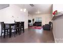 Open-concept living and dining area featuring hardwood floors and comfortable seating arrangements at 6919 Ware Rd, Charlotte, NC 28212