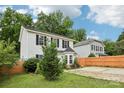 Exterior view of a two-story home with white siding, a manicured lawn, and a wooden fence at 719 Dawn Cir, Charlotte, NC 28213