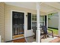 Inviting front porch with a dark front door, rocking chairs, and charming decor at 820 Settlement St, Clover, SC 29710