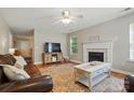 Cozy living room with fireplace, area rug, ceiling fan, and comfortable furniture at 820 Settlement St, Clover, SC 29710