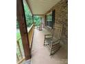 Inviting front porch with rocking chairs, perfect for enjoying the outdoors and a beautiful view at 8819 Noah Helms Rd, Indian Trail, NC 28079