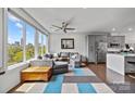 Inviting living room with expansive windows, a comfortable grey sectional, and modern decor at 919 Cityscape Dr, Charlotte, NC 28205